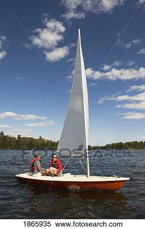 Couple in sailboat, Lake of the Woods, Ontario, Canada View Large Photo Image Stock Photography - Couple in sailboat, Lake of the Woods, Ontario, Canada. Fotosearch