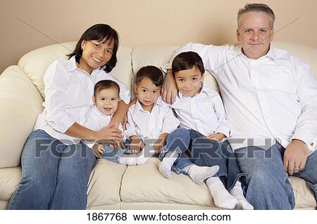 Family sitting on a couch View Large Photo Image Stock Photo - Family sitting on a couch. Fotosearch