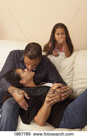 Girl catching her parents kissing View Large Photo Image Stock Photo - Girl catching her parents kissing. Fotosearch