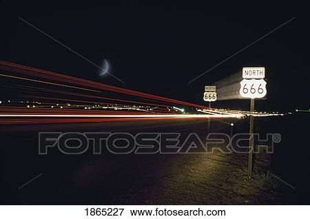 Stock Photo - Highway 666 at night with light trails from vehicles. Fotosearch