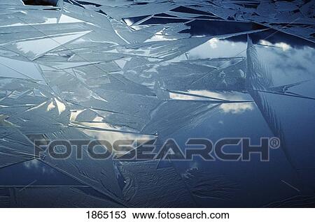 Stock Image - Ice forming on water surface. Fotosearch