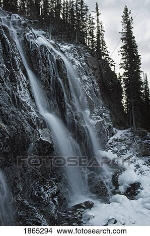 Picture - Icy waterfall on mountainside, Rocky Mountains. Fotosearch