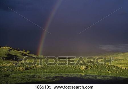 Stock Photography - Rainbow over valley in Yellowstone National Park, Wyoming, USA. Fotosearch