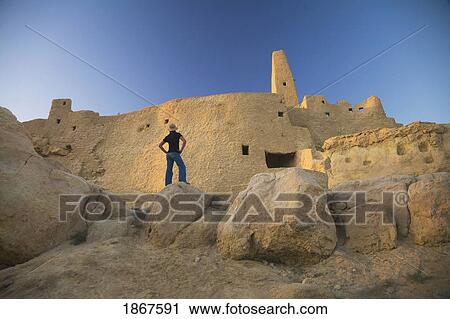 Stock Image - Woman tourist at The Temple of the Oracle (Temple of Amun) at the Siwa Oasis in Egypt. Fotosearch