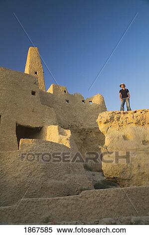 Woman tourist at The Temple of the Oracle (Temple of Amun) at the Siwa Oasis in Egypt View Large Photo Image Stock Photography - Woman tourist at The Temple of the Oracle (Temple of Amun) at the Siwa Oasis in Egypt. Fotosearch