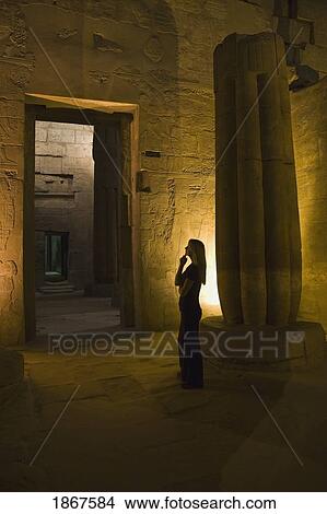 Picture - Woman tourist in Luxor Temple at night, Egypt. Fotosearch