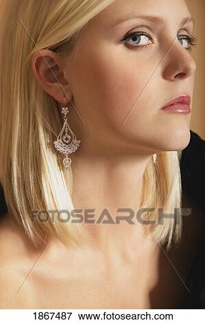 Woman with long earrings View Large Photo Image Stock Photo - Woman with long earrings. Fotosearch