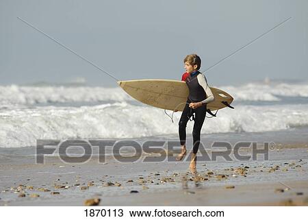 a boy running with a surfboard down the beach View Large Photo Image Stock Image - a boy running with a surfboard down the beach. Fotosearch