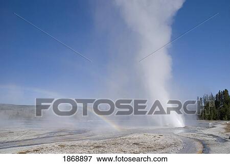 Stock Photo - a geyser with water shooting out and forming a rainbow. Fotosearch