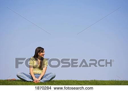 a girl sitting on the grass View Large Photo Image Picture - a girl sitting on the grass. Fotosearch