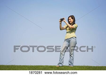 a girl taking a picture with her camera View Large Photo Image Stock Image - a girl taking a picture with her camera. Fotosearch
