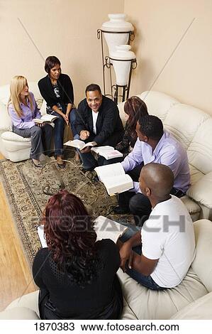 a group of adults in a home bible study View Large Photo Image Stock Image - a group of adults in a home bible study. Fotosearch