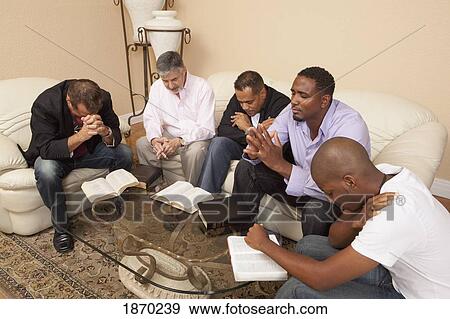 a group of men praying together View Large Photo Image Stock Photo - a group of men praying together. Fotosearch