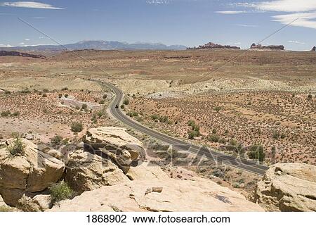 Stock Image - a road going towards the mountains. Fotosearch