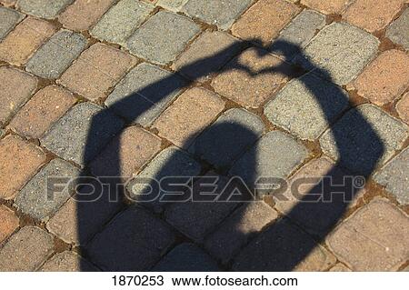 a shadow of hands making a heart shape View Large Photo Image Stock Image - a shadow of hands making a heart shape. Fotosearch