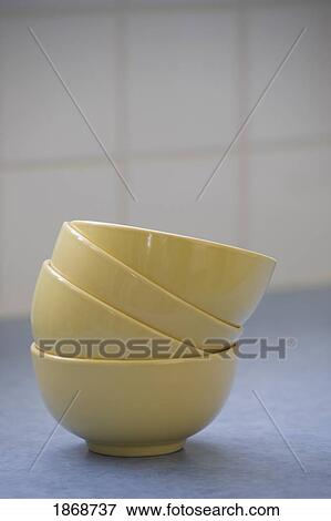 a stack of yellow bowls View Large Photo Image Stock Photo - a stack of yellow bowls. Fotosearch