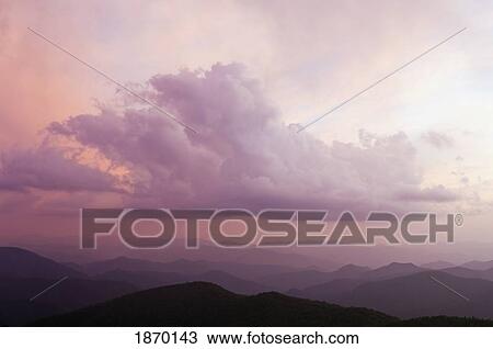 Stock Image - blue ridge parkway, north carolina, united states of america; clearing storm clouds at sunset over the black mountains. Fotosearch