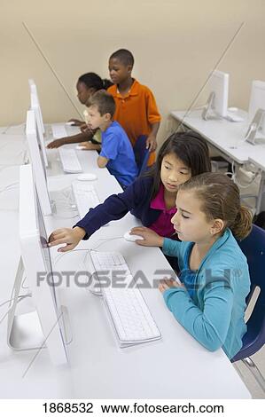 Stock Image - children working together on computers. Fotosearch
