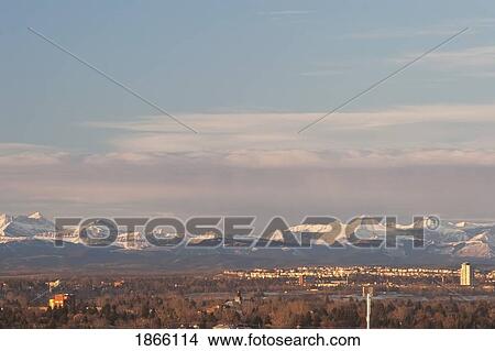 City skyline against mountain backdrop, Calgary, Alberta, Canada View Large Photo Image Picture - City skyline against mountain backdrop, Calgary, Alberta, Canada. Fotosearch