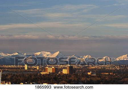 Stock Image - City skyline with mountain backdrop, Calgary, Alberta, Canada. Fotosearch