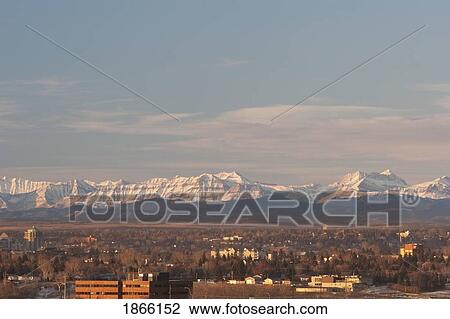 Stock Image - City skyline with mountain backdrop, Calgary, Alberta, Canada. Fotosearch