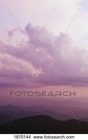 Picture - clouds over the mountains at sunset. Fotosearch