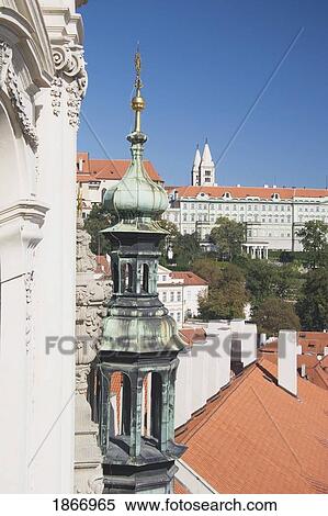 Stock Photography - copper tower and rooftops, prague, czech republic. Fotosearch