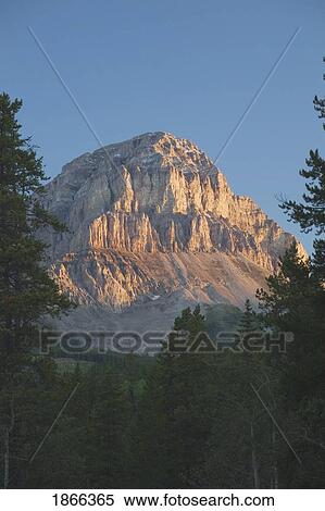 Stock Photography - Crowsnest Mountain at sunrise, Crowsnest Pass, Alberta, Canada. Fotosearch