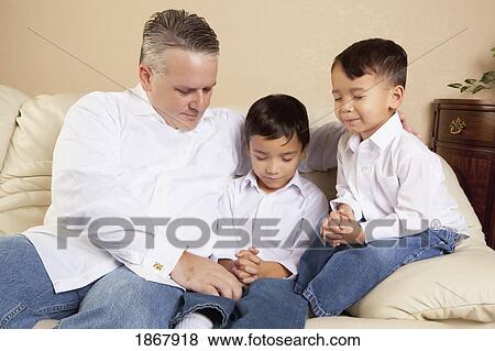 father praying with his sons View Large Photo Image Stock Photo - father praying with his sons. Fotosearch