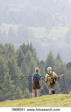Stock Image - female hikers, siusi allo sciliar, alto adige, italy. Fotosearch