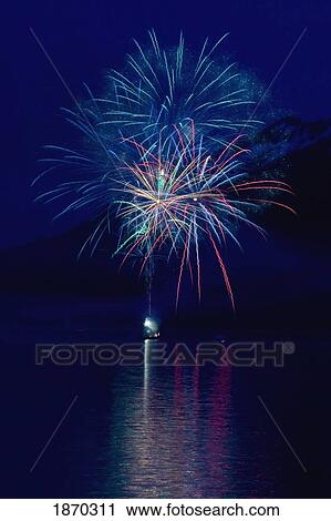 fireworks over the water with a mountain in the background View Large Photo Image Stock Image - fireworks over the water with a mountain in the background. Fotosearch