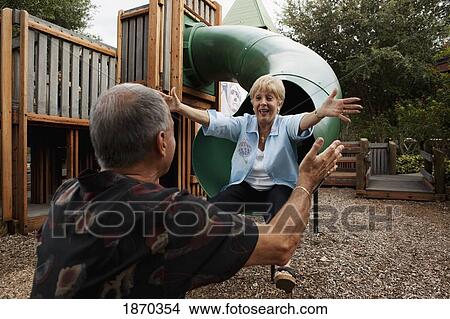 fort lauderdale, florida, united states of america; a couple playing at a playground View Large Photo Image Picture - fort lauderdale, florida, united states of america; a couple playing at a playground. Fotosearch
