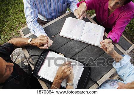 fort lauderdale, florida, united states of america; two couples praying together with their bibles open View Large Photo Image Picture - fort lauderdale, florida, united states of america; two couples praying together with their bibles open. Fotosearch