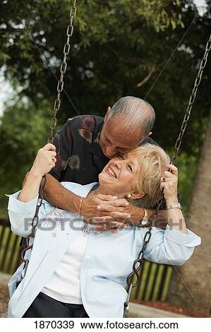 fort lauderdale, florida, united states of america; a couple with the woman sitting on a swing View Large Photo Image Stock Photo - fort lauderdale, florida, united states of america; a couple with the woman sitting on a swing. Fotosearch