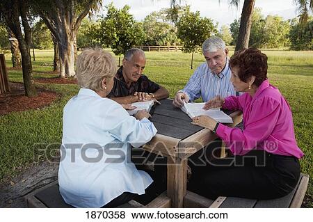 Stock Photo - fort lauderdale, florida, united states of america; two couples studying the bible together. Fotosearch