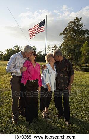 fort lauderdale, florida, united states of america; two couples kissing with the america flag flying overhead View Large Photo Image Stock Photo - fort lauderdale, florida, united states of america; two couples kissing with the america flag flying overhead. Fotosearch