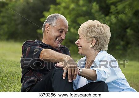 fort lauderdale, florida, united states of america; a couple sitting together on the grass View Large Photo Image Stock Photograph - fort lauderdale, florida, united states of america; a couple sitting together on the grass. Fotosearch