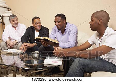 Stock Photograph - four men studying the bible. Fotosearch