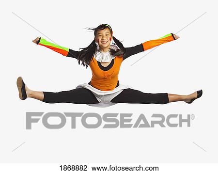 Stock Image - girl jumping with legs and arms outstretched. Fotosearch