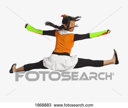 Stock Image - girl jumping with legs and arms outstretched. Fotosearch