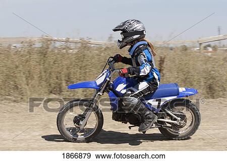 Stock Photo - Girl on a motorcross bike. Fotosearch