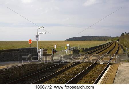 Stock Image - grange-over-sands, westmorland, england; pedestrian crossing over railroad tracks. Fotosearch