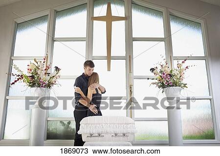 grieving young couple standing with a baby's coffin View Large Photo Image Stock Image - grieving young couple standing with a baby's coffin. Fotosearch