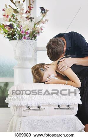 grieving young couple with an infant's coffin View Large Photo Image Stock Photo - grieving young couple with an infant's coffin. Fotosearch