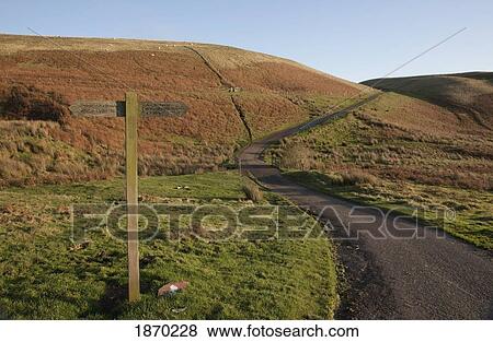 Stock Photo - hazeltonrig, northumberland, england; a road leading up a hill. Fotosearch