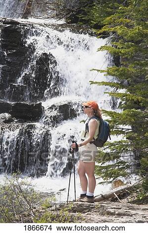 Hiker looking a waterfalls View Large Photo Image Picture - Hiker looking a waterfalls. Fotosearch
