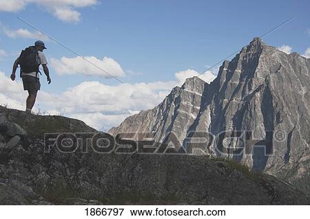 Stock Photo - Hiker on a mountain ridge. Fotosearch