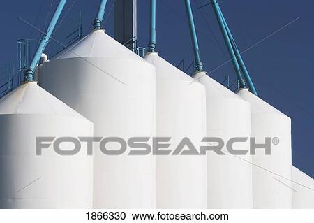 Stock Image - Large metal grain bins, Alberta, Canada. Fotosearch