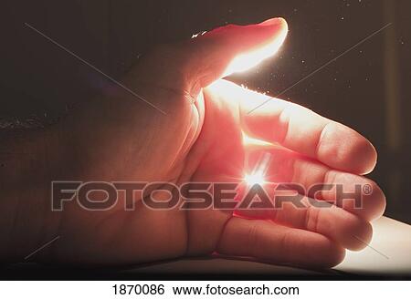 Stock Photograph - light shining onto a hand. Fotosearch