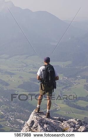 male hiker overlooking a valley, bad ischl, salzkammergut, austria View Large Photo Image Stock Photo - male hiker overlooking a valley, bad ischl, salzkammergut, austria. Fotosearch